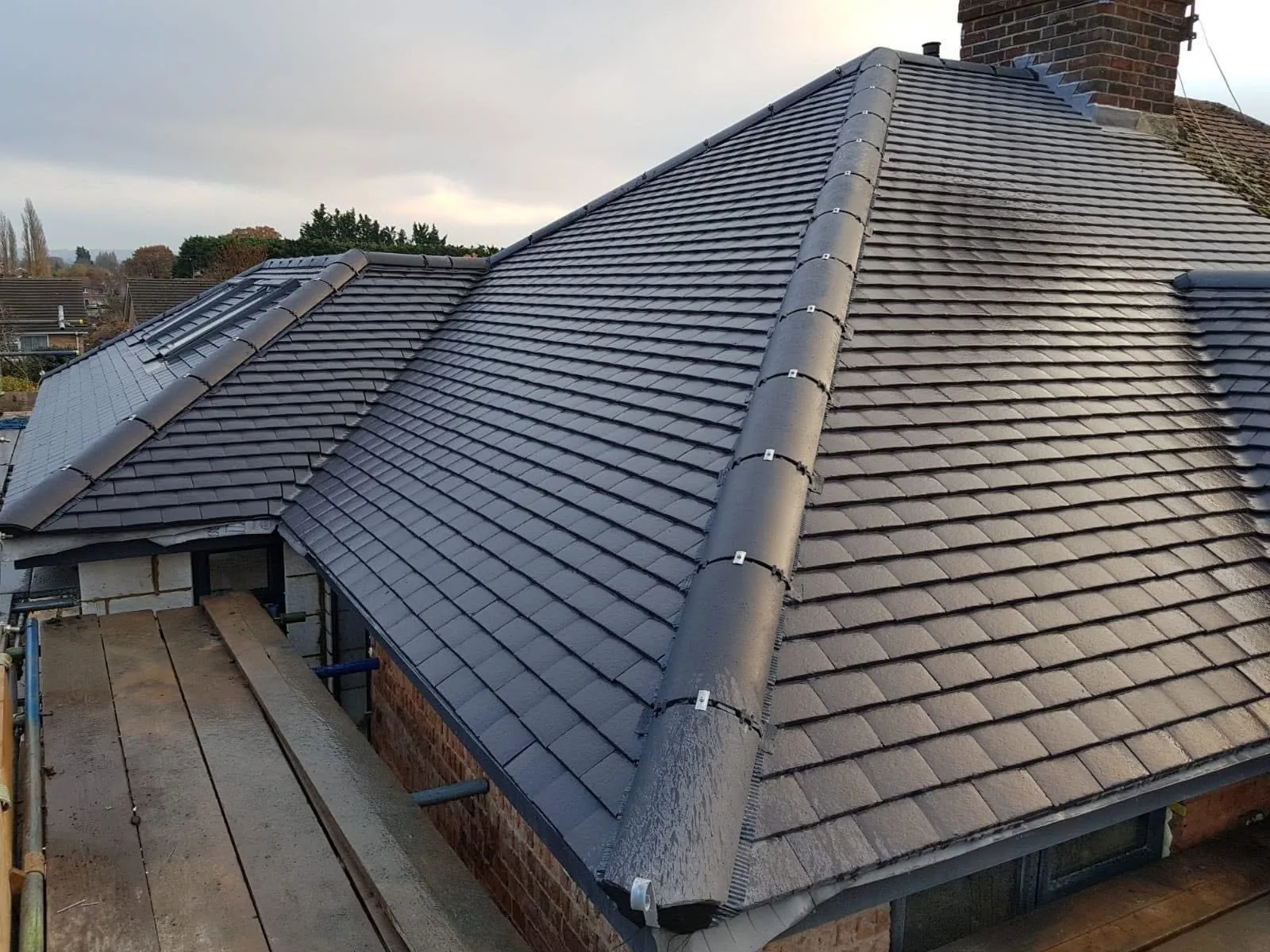 Completed dark tiled roof